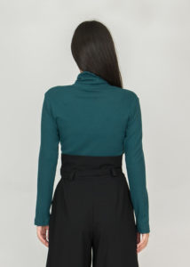 Dark green turtleneck with black trousers