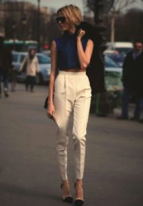 beige high-waisted trousers and blue blouse