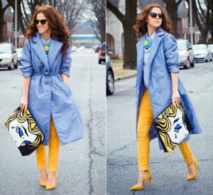 Yellow shoes under a blue raincoat