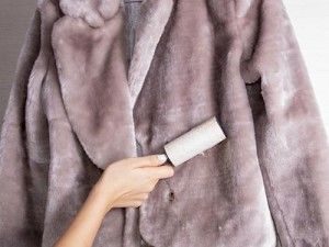 cleaning a fur coat with a sticky roller