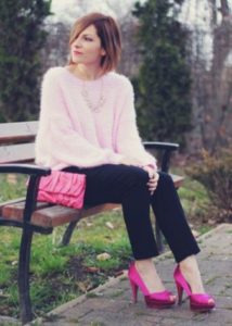 lys pink sweater og sorte bukser