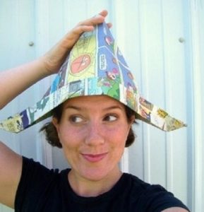 Woman in a newspaper hat