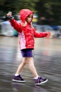 girl in sneakers on wheels