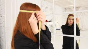 measuring your head in front of a mirror