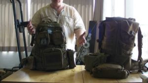 man packing a backpack