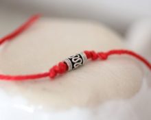 red thread with an amulet