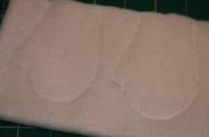 We trace it onto the padding polyester