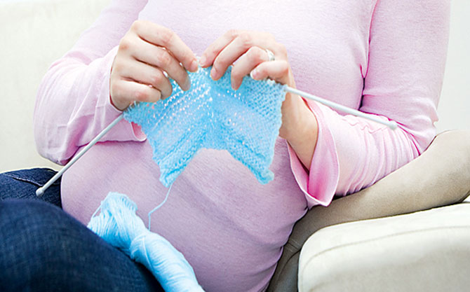 Pregnant woman knitting