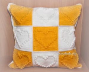 White and orange motif pillow